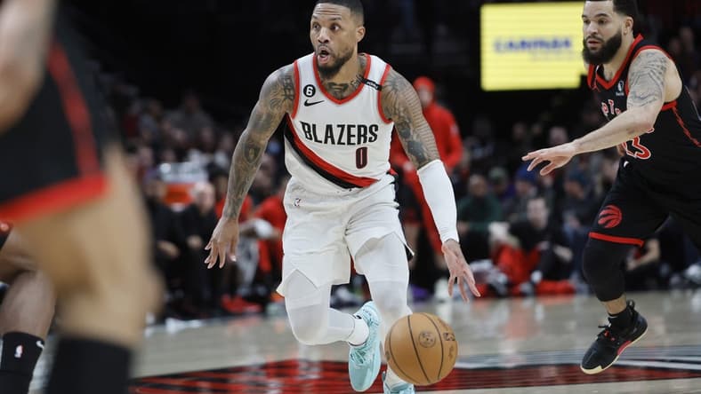 Jan 28, 2023; Portland, Oregon, USA; Portland Trail Blazers point guard Damian Lillard (0) dribbles the ball past Toronto Raptors shooting guard Fred VanVleet (23) during the first half at Moda Center. Mandatory Credit: Soobum Im-USA TODAY Sports