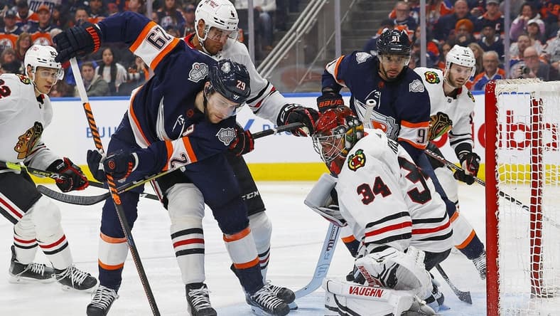 Jan 28, 2023; Edmonton, Alberta, CAN; Edmonton Oilers forward Leon Draisaitl (29) goes for a loose puck in front of Chicago Blackhawks goaltender Petr Mrazek (34) during the third period at Rogers Place. Mandatory Credit: Perry Nelson-USA TODAY Sports