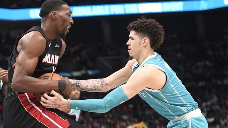 Jan 29, 2023; Charlotte, North Carolina, USA; Charlotte Hornets guard LaMelo Ball (1) tries to steal the ball from Miami Heat forward center Bam Adebayo (13) during the first half at the Spectrum Center. Mandatory Credit: Sam Sharpe-USA TODAY Sports