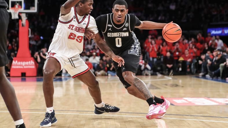 Jan 29, 2023; New York, New York, USA; Georgetown Hoyas guard Brandon Murray (0) looks to drive past St. John's Red Storm forward David Jones (23) in the first half at Madison Square Garden. Mandatory Credit: Wendell Cruz-USA TODAY Sports
