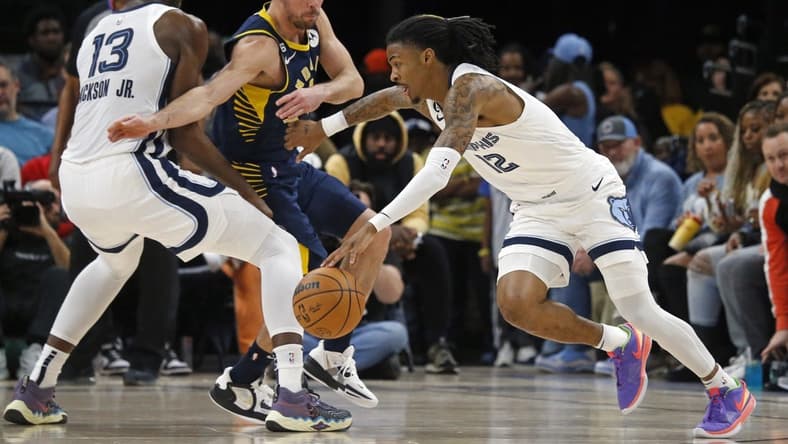 Jan 29, 2023; Memphis, Tennessee, USA; Memphis Grizzlies guard Ja Morant (12) dribbles around a screen set by forward Jaren Jackson Jr. (13) on Indiana Pacers guard T.J. McConnell (9) during the first half at FedExForum. Mandatory Credit: Petre Thomas-USA TODAY Sports