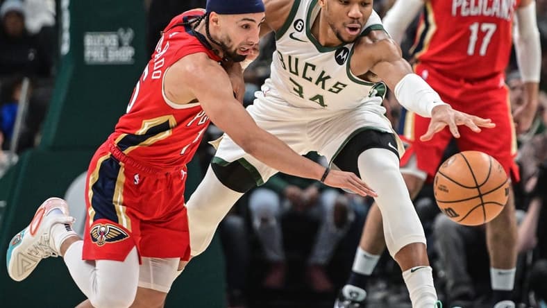 Jan 29, 2023; Milwaukee, Wisconsin, USA; Milwaukee Bucks forward Giannis Antetokounmpo (34) and New Orleans Pelicans guard Jose Alvarado (15) reach for a loose ball in the first quarter at Fiserv Forum. Mandatory Credit: Benny Sieu-USA TODAY Sports