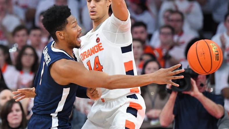 Jan 30, 2023; Syracuse, New York, USA; Virginia Cavaliers forward Jayden Gardner (1) passes the ball around Syracuse Orange center Jesse Edwards (14) during the first half at the JMA Wireless Dome. Mandatory Credit: Rich Barnes-USA TODAY Sports