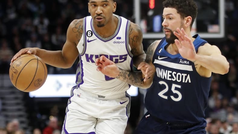 Jan 30, 2023; Minneapolis, Minnesota, USA; Sacramento Kings guard Malik Monk (0) works around Minnesota Timberwolves guard Austin Rivers (25) in the second quarter at Target Center. Mandatory Credit: Bruce Kluckhohn-USA TODAY Sports