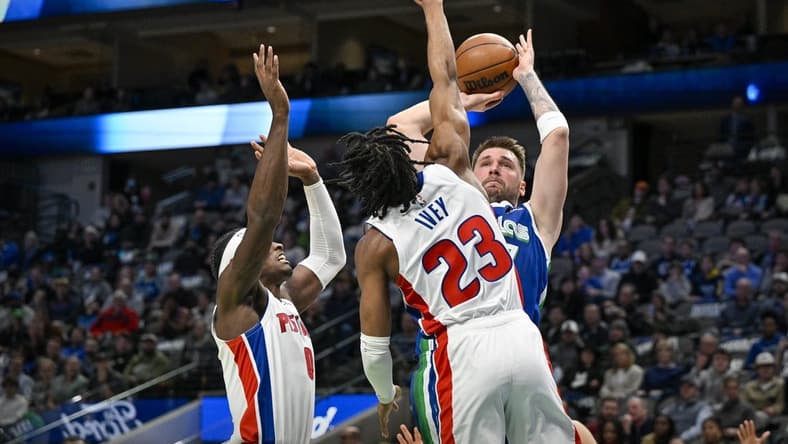 Jan 30, 2023; Dallas, Texas, USA; Dallas Mavericks guard Luka Doncic (77) looks to passes the ball over Detroit Pistons guard Jaden Ivey (23) and center Jalen Duren (0) during the first quarter at the American Airlines Center. Mandatory Credit: Jerome Miron-USA TODAY Sports