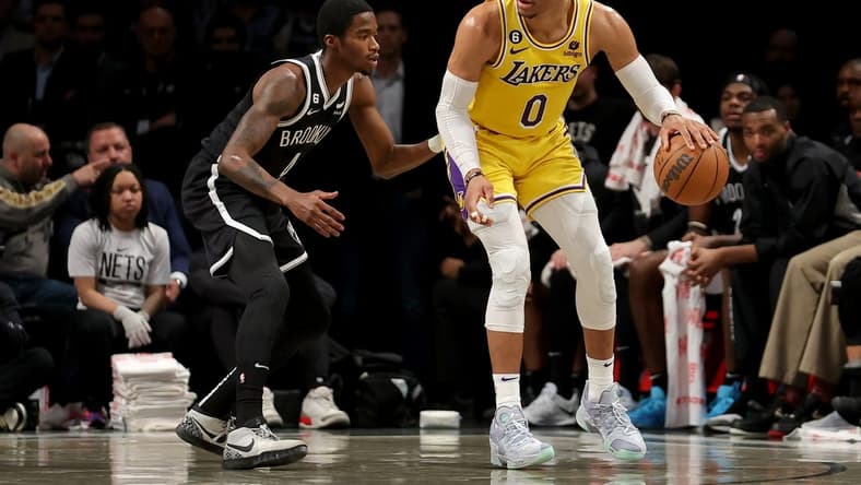 Jan 30, 2023; Brooklyn, New York, USA; Los Angeles Lakers guard Russell Westbrook (0) controls the ball against Brooklyn Nets guard Edmond Sumner (4) during the second quarter at Barclays Center. Mandatory Credit: Brad Penner-USA TODAY Sports