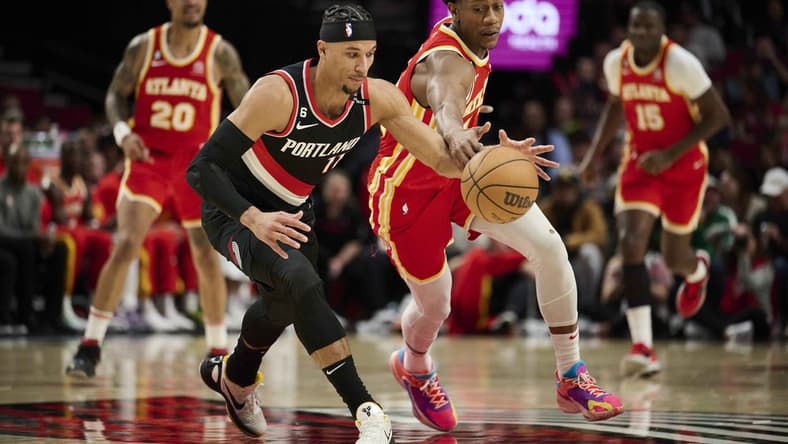 Jan 30, 2023; Portland, Oregon, USA; Portland Trail Blazers guard Josh Hart (11) controls the basketball during the first half against Atlanta Hawks forward De'Andre Hunter (12) at Moda Center. Mandatory Credit: Troy Wayrynen-USA TODAY Sports