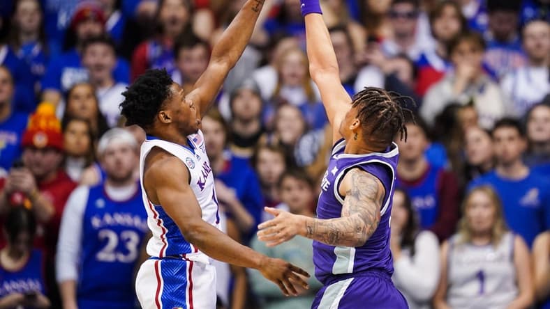 Jan 31, 2023; Lawrence, Kansas, USA; Kansas Jayhawks guard Joseph Yesufu (1) shoots against Kansas State Wildcats forward Keyontae Johnson (11) during the first half at Allen Fieldhouse. Mandatory Credit: Jay Biggerstaff-USA TODAY Sports