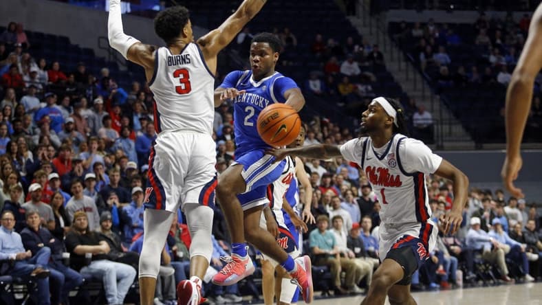 Jan 31, 2023; Oxford, Mississippi, USA; Kentucky Wildcats guard Sahvir Wheeler (2) passes the ball as Mississippi Rebels forward Myles Burns (3) and guard Amaree Abram (1) defend during the first half at The Sandy and John Black Pavilion at Ole Miss. Mandatory Credit: Petre Thomas-USA TODAY Sports