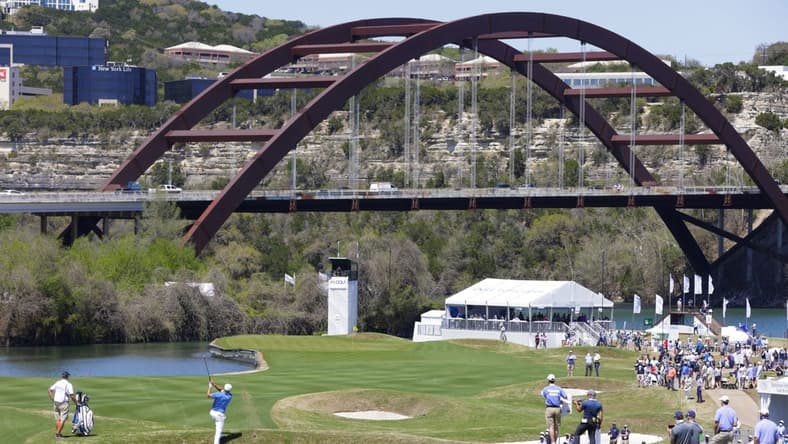 Mar 25, 2021; Austin, Texas, USA; Bryson DeChambeau hits his approach on #12 during the second day of the WGC Dell Technologies Match Play golf tournament at Austin Country Club. The Pennybacker Bridge, one of the signature landmarks of Austin, spans Lake Austin in the background. Mandatory Credit: Erich Schlegel-USA TODAY Sports