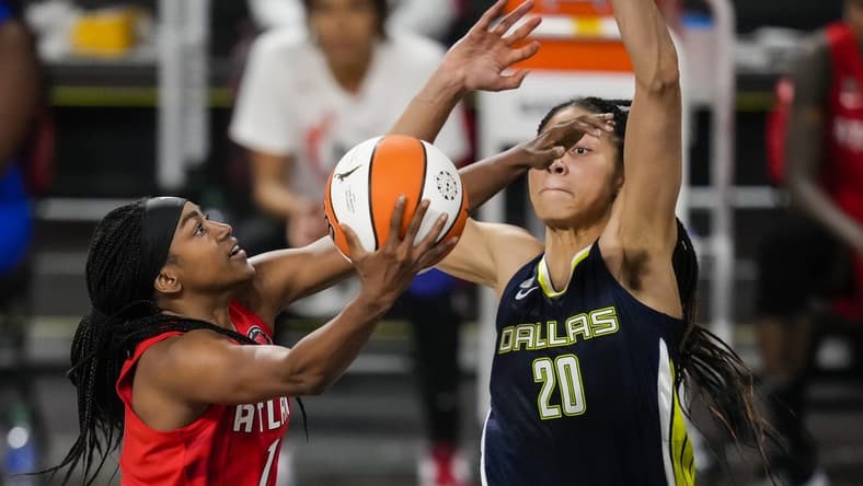 May 27, 2021; College Park, Georgia, USA; Atlanta Dream center/forward Elizabeth Williams (1) drives to the basket against Dallas Wings forward Isabelle Harrison (20) during the second half at Gateway Center Arena at College Park. Mandatory Credit: Dale Zanine-USA TODAY Sports