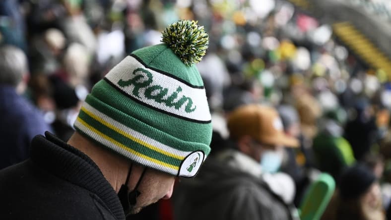Feb 26, 2022; Portland, Oregon, USA; A Portland Timbers fan keeps warm in a stocking cap before a game against the New England Revolution at Providence Park. The weather report calls for rain on opening day. Mandatory Credit: Troy Wayrynen-USA TODAY Sports