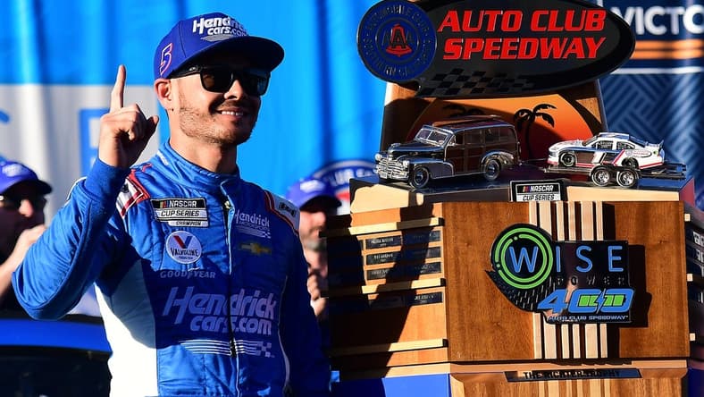 Feb 27, 2022; Fontana, California, USA; NASCAR Cup Series driver Kyle Larson (5) celebrates his victory of the WISE Power 400 at Auto Club Speedway. Mandatory Credit: Gary A. Vasquez-USA TODAY Sports