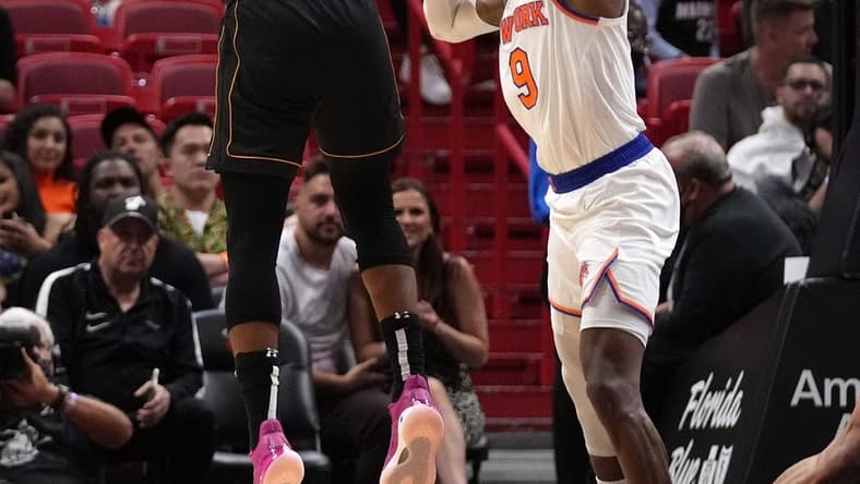 Mar 25, 2022; Miami, Florida, USA; Miami Heat forward Jimmy Butler (22) shoots the ball over New York Knicks guard RJ Barrett (9) during the second half at FTX Arena. Mandatory Credit: Jasen Vinlove-USA TODAY Sports