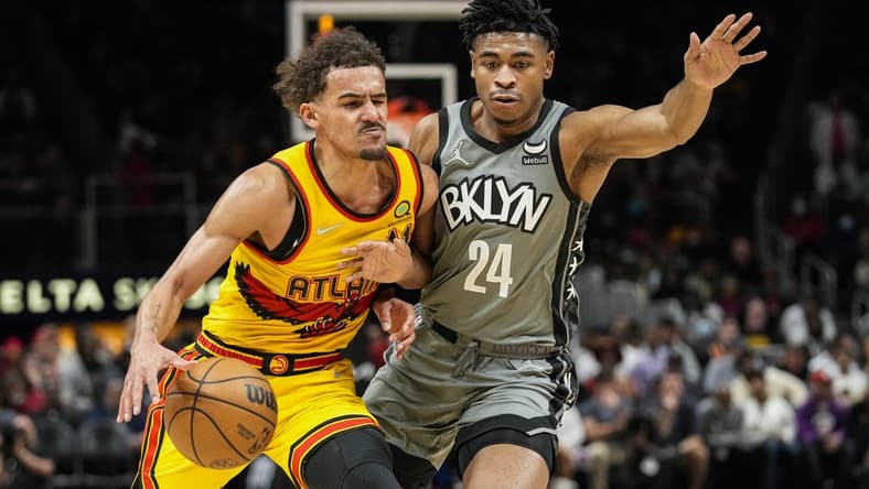 Apr 2, 2022; Atlanta, Georgia, USA; Atlanta Hawks guard Trae Young (11) is guarded by Brooklyn Nets guard Cam Thomas (24) during the second half at State Farm Arena. Mandatory Credit: Dale Zanine-USA TODAY Sports