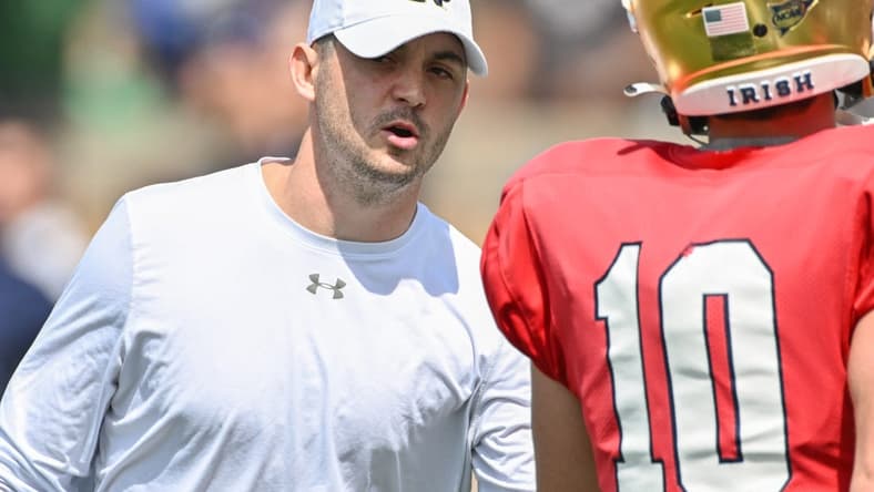 Apr 23, 2022; Notre Dame, Indiana, USA; Notre Dame Fighting Irish offensive coordinator Tommy Rees talks to quarterback Drew Pyne (10) during warmups before the Blue-Gold Game at Notre Dame Stadium. Mandatory Credit: Matt Cashore-USA TODAY Sports