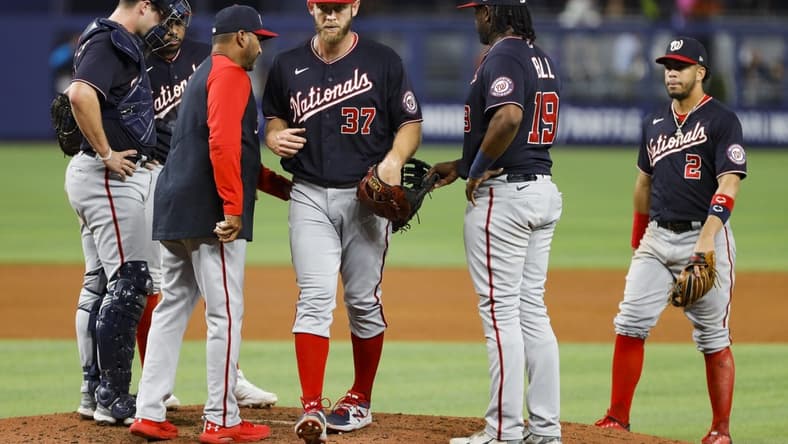Jun 9, 2022; Miami, Florida, USA; Washington Nationals manager Dave Martinez (4) takes starting pitcher Stephen Strasburg (37) out of the game in the fifth inning against the Miami Marlins at loanDepot Park. Mandatory Credit: Sam Navarro-USA TODAY Sports