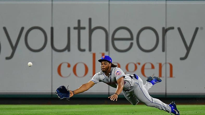 Jun 11, 2022; Anaheim, California, USA; New York Mets center fielder Khalil Lee (26) misses catching the two run RBI triple hit by Los Angeles Angels first baseman Jared Walsh (20) during the eighth inning at Angel Stadium. Mandatory Credit: Gary A. Vasquez-USA TODAY Sports