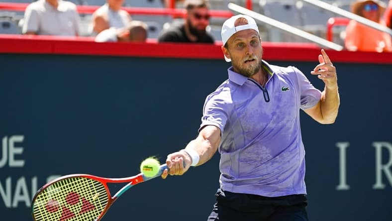 Aug 6, 2022; Montreal, Quebec, Canada; Denis Kudla (USA) hits a shot against Benoit Paire (FRA) (not pictured) in first round qualifying play at IGA Stadium. Mandatory Credit: David Kirouac-USA TODAY Sports
