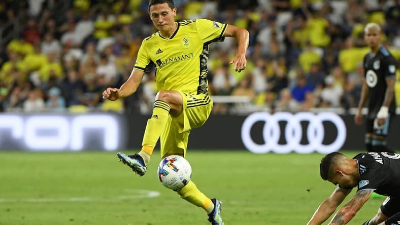 Aug 14, 2022; Nashville, Tennessee, USA; Nashville SC defender Eric Miller (15) kicks the ball against the Minnesota United FC during the second half at Geodis Park. Mandatory Credit: Steve Roberts-USA TODAY Sports