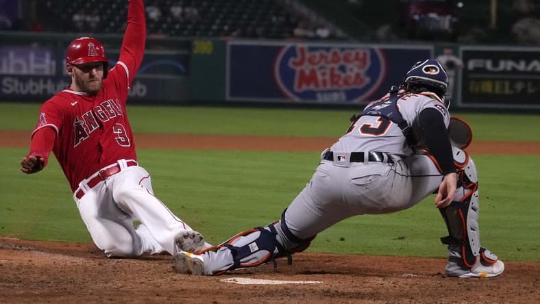 Sep 6, 2022; Anaheim, California, USA; Los Angeles Angels right fielder Taylor Ward (3) slides into home plate to beat a throw to Detroit Tigers catcher Tucker Barnhart (15) to score in the 10th inning at Angel Stadium. Mandatory Credit: Kirby Lee-USA TODAY Sports