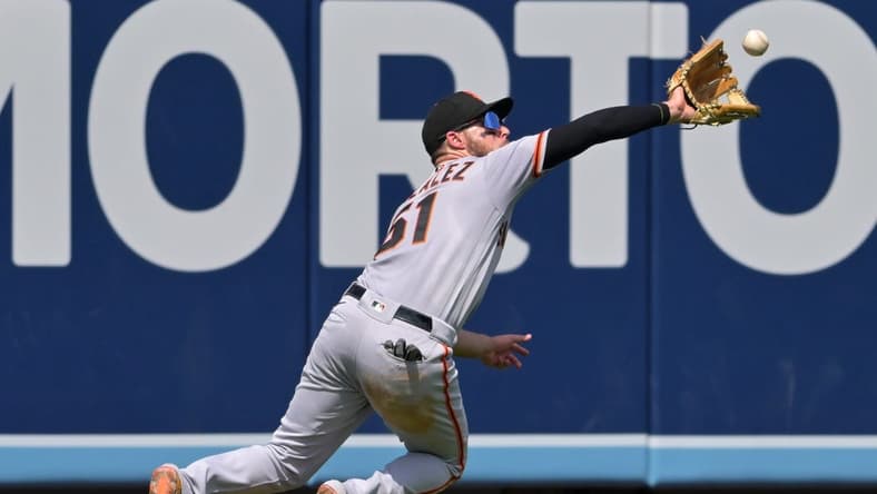 Sep 7, 2022; Los Angeles, California, USA; San Francisco Giants right fielder Luis Gonzalez (51) makes a catch off a ball hit by Los Angeles Dodgers third baseman Miguel Vargas (not pictured) in the fourth inning at Dodger Stadium. Mandatory Credit: Jayne Kamin-Oncea-USA TODAY Sports