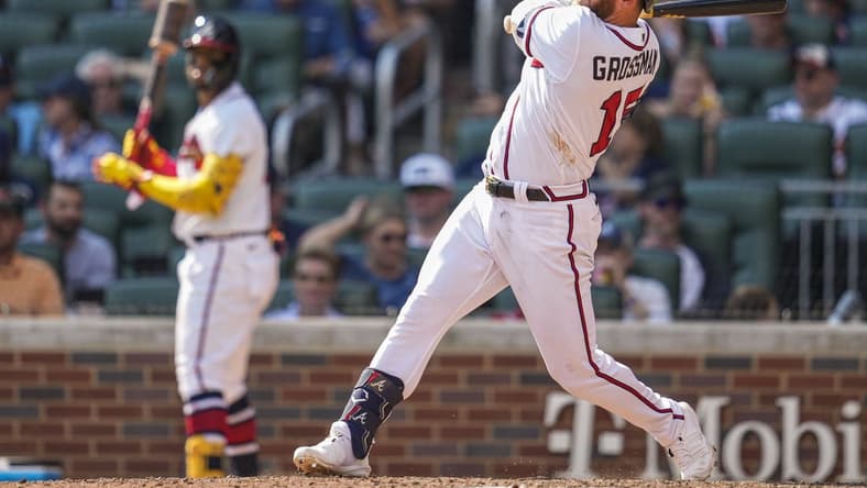 Sep 18, 2022; Cumberland, Georgia, USA; Atlanta Braves left fielder Robbie Grossman (15) hits a home run against the Philadelphia Phillies during the seventh inning at Truist Park. Mandatory Credit: Dale Zanine-USA TODAY Sports