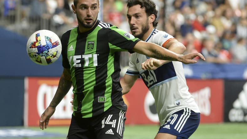 Oct 1, 2022; Vancouver, British Columbia, CAN;  Austin FC midfielder Diego Fagundez (14) takes possession of the ball against Vancouver Whitecaps FC forward Russell Teibert (31) during the second half at BC Place. Mandatory Credit: Anne-Marie Sorvin-USA TODAY Sports