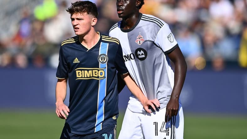 Oct 9, 2022; Philadelphia, Pennsylvania, USA; Philadelphia Union midfielder Jack Mcglynn (16) defends Toronto FC midfielder Noble Okello (14) in the first half at Subaru Park. Mandatory Credit: Kyle Ross-USA TODAY Sports