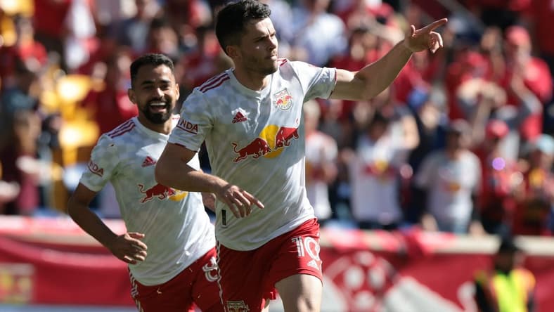 Oct 15, 2022; Harrison, New Jersey, USA; New York Red Bulls midfielder Lewis Morgan (10) celebrates with midfielder Luquinhas (82) after scoring a goal against FC Cincinnati during the second half at Red Bull Arena. Mandatory Credit: Vincent Carchietta-USA TODAY Sports