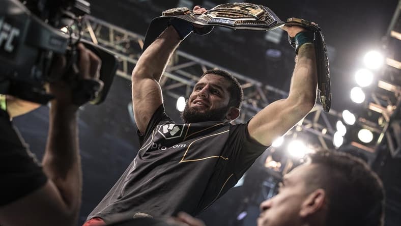 Oct 22, 2022; Abu Dhabi, UAE;   Islam Makhachev (blue gloves) celebrates with the title belt after defeating Charles Oliveira (red gloves) during UFC 280 at Etihad Arena. Mandatory Credit: Craig Kidwell-USA TODAY Sports