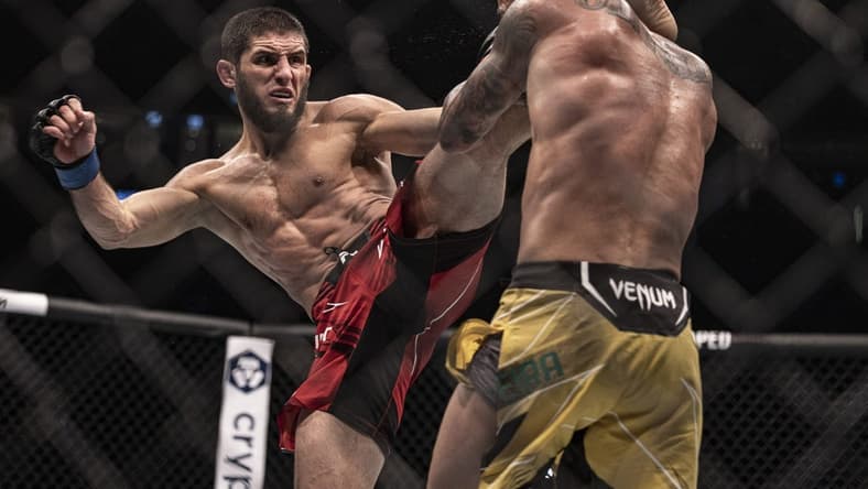 Oct 22, 2022; Abu Dhabi, UAE; Charles Oliveira (red gloves) and Islam Makhachev (blue gloves) during UFC 280 at Etihad Arena. Mandatory Credit: Craig Kidwell-USA TODAY Sports