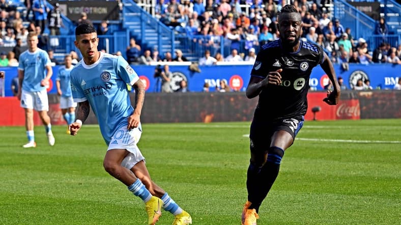 Oct 23, 2022; Montreal, Quebec, Canada; CF Montreal forward Kei Kamara (23) and New York City midfielder Santiago Rodriguez (20) go for the ball during the first half during the conference semifinals for the Audi 2022 MLS Cup Playoffs at Stade Saputo. Mandatory Credit: David Kirouac-USA TODAY Sports
