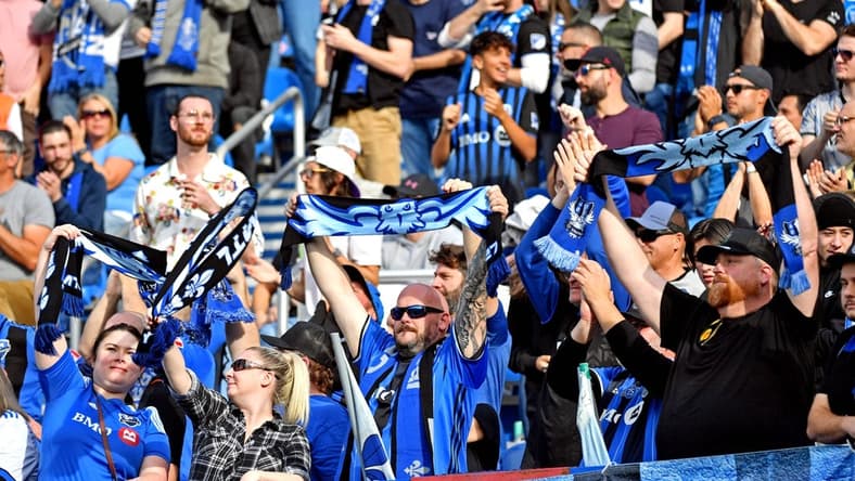 Oct 23, 2022; Montreal, Quebec, Canada; Fans cheer during the game between the CF Montreal and the New York City during the conference semifinals for the Audi 2022 MLS Cup Playoffs at Stade Saputo. Mandatory Credit: Marc DesRosiers-USA TODAY Sports