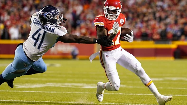 Nov 6, 2022; Kansas City, Missouri, USA; Kansas City Chiefs wide receiver Mecole Hardman (17) runs the ball against Tennessee Titans linebacker Zach Cunningham (41) during the first half at GEHA Field at Arrowhead Stadium. Mandatory Credit: Jay Biggerstaff-USA TODAY Sports