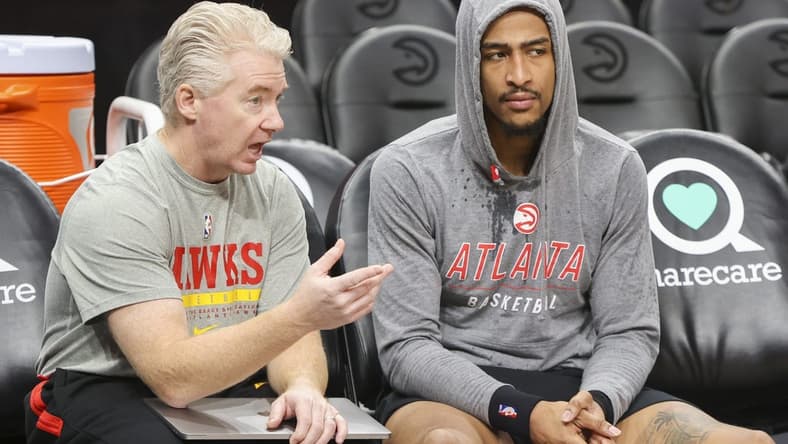 Nov 10, 2022; Atlanta, Georgia, USA; Atlanta Hawks lead assistant coach Joe Prunty talks to forward John Collins (20) before a game against the Philadelphia 76ers at State Farm Arena. Mandatory Credit: Brett Davis-USA TODAY Sports