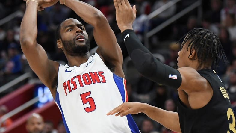 Nov 27, 2022; Detroit, Michigan, USA; Detroit Pistons guard Alec Burks (5) puts up shot over Cleveland Cavaliers guard Isaac Okoro (35) in the third quarter at Little Caesars Arena. Mandatory Credit: Lon Horwedel-USA TODAY Sports
