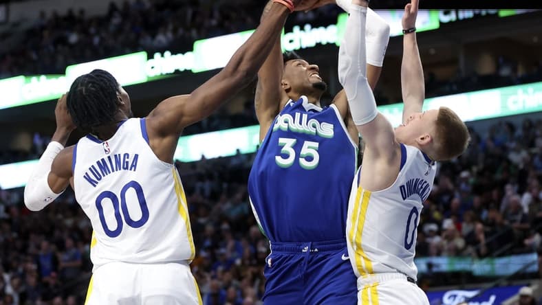 Nov 29, 2022; Dallas, Texas, USA; Dallas Mavericks center Christian Wood (35) shoots as Golden State Warriors forward Jonathan Kuminga (00) and Golden State Warriors guard Donte DiVincenzo (0) defends during the second half at American Airlines Center. Mandatory Credit: Kevin Jairaj-USA TODAY Sports