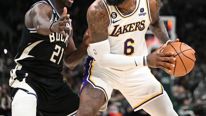 Dec 2, 2022; Milwaukee, Wisconsin, USA; Los Angeles Lakers forward LeBron James (6) posts up against Milwaukee Bucks guard Jrue Holiday (21) in the second quarter at Fiserv Forum. Mandatory Credit: Michael McLoone-USA TODAY Sports