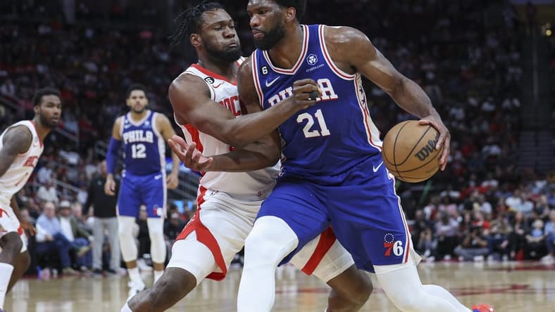 Dec 5, 2022; Houston, Texas, USA; Philadelphia 76ers center Joel Embiid (21) controls the ball as Houston Rockets forward Bruno Fernando (20) defends during the third quarter at Toyota Center. Mandatory Credit: Troy Taormina-USA TODAY Sports