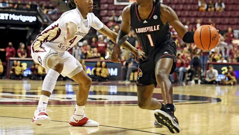 Dec 10, 2022; Tallahassee, Florida, USA; Louisville Cardinals guard Mike James (1) moves to the net as Florida State Seminoles guard Caleb Mills (4) defends during the first half at Donald L. Tucker Center. Mandatory Credit: Melina Myers-USA TODAY Sports