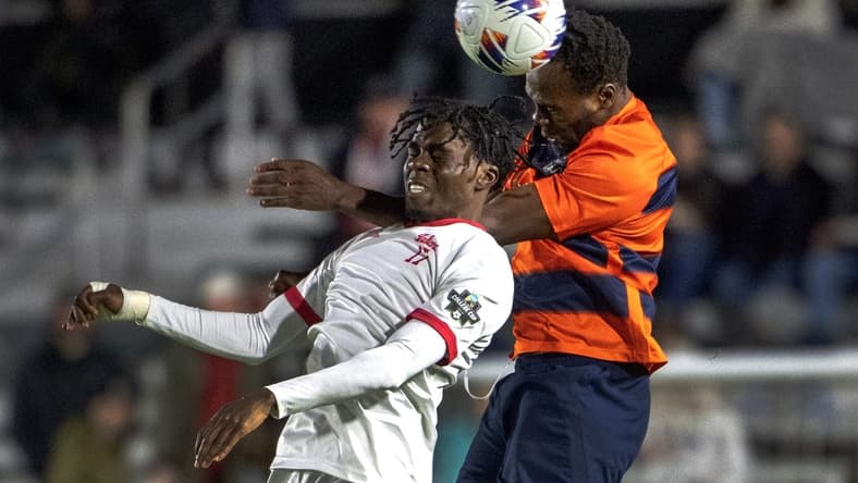 Dec 12, 2022; Cary, NC, USA; Syracuse defender Abdi Salim (3) heads the ball over Indiana forward Herbert Endeley (17) in the first half at WakeMed Soccer Park. Mandatory Credit: Bob Donnan-USA TODAY Sports