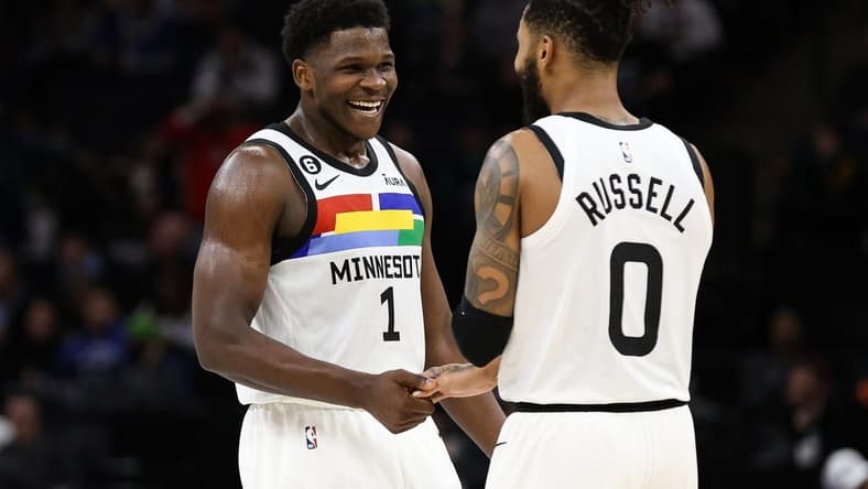 Dec 18, 2022; Minneapolis, Minnesota, USA; Minnesota Timberwolves guard Anthony Edwards (1) and guard D'Angelo Russell (0) celebrate during the third quarter against the Chicago Bulls at Target Center. Mandatory Credit: Matt Krohn-USA TODAY Sports