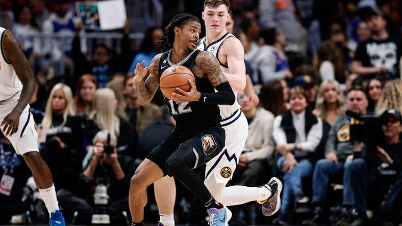 Dec 20, 2022; Denver, Colorado, USA; Memphis Grizzlies guard Ja Morant (12) controls the ball as Denver Nuggets guard Christian Braun (0) guards in the third quarter at Ball Arena. Mandatory Credit: Isaiah J. Downing-USA TODAY Sports