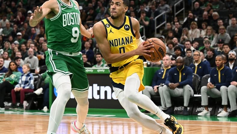 Dec 21, 2022; Boston, Massachusetts, USA; Indiana Pacers guard Tyrese Haliburton (0) drives to the basket against Boston Celtics guard Derrick White (9) during the first quarter at the TD Garden. Mandatory Credit: Brian Fluharty-USA TODAY Sports