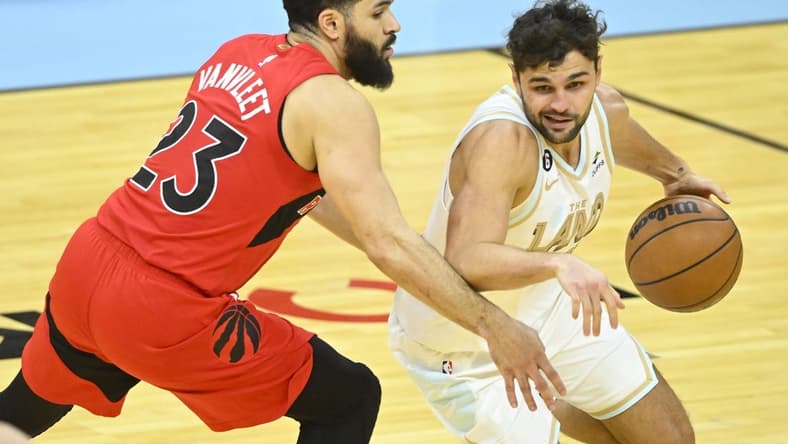 Dec 23, 2022; Cleveland, Ohio, USA; Cleveland Cavaliers guard Raul Neto (19) dribbles beside Toronto Raptors guard Fred VanVleet (23) in the third quarter at Rocket Mortgage FieldHouse. Mandatory Credit: David Richard-USA TODAY Sports