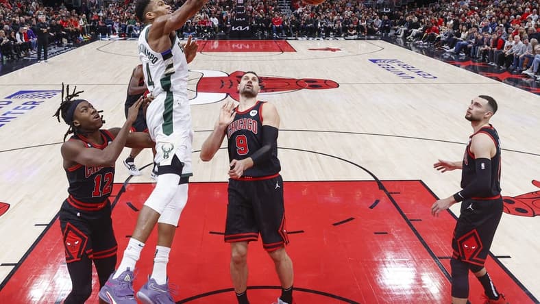 Dec 28, 2022; Chicago, Illinois, USA; Giannis Antetokounmpo (34) scores against the Chicago Bulls during the second half at United Center. Mandatory Credit: Kamil Krzaczynski-USA TODAY Sports