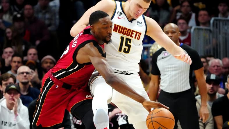 Dec 30, 2022; Denver, Colorado, USA; Miami Heat center Bam Adebayo (13) steals the ball away from Denver Nuggets center Nikola Jokic (15) in the second half at Ball Arena. Mandatory Credit: Ron Chenoy-USA TODAY Sports
