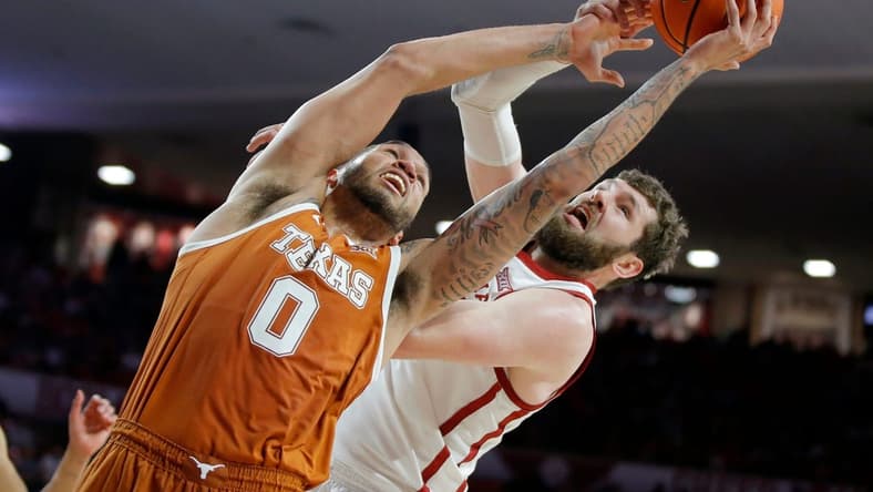 Texas Longhorns forward Timmy Allen (0) and Oklahoma Sooners forward Tanner Groves (35) reach for the ball during an NCAA men's college basketball game between the University of Oklahoma and Texas at Lloyd Noble Center in Norman, Okla., Saturday, Dec. 31, 2022. Texas won 70-69.
Oklahoma Vs Texas Basketball