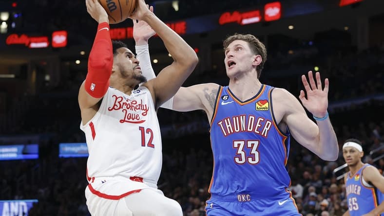 Dec 31, 2022; Oklahoma City, Oklahoma, USA; Philadelphia 76ers forward Tobias Harris (12) shoots the ball against Oklahoma City Thunder center Mike Muscala (33) during the second quarter at Paycom Center. Mandatory Credit: Alonzo Adams-USA TODAY Sports